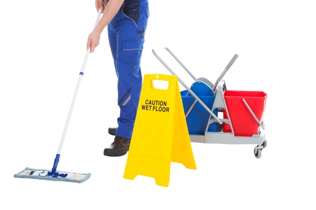 Person mopping floor with caution sign and buckets