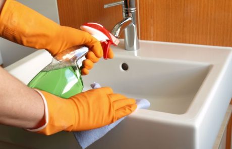 Person cleaning bathroom sink