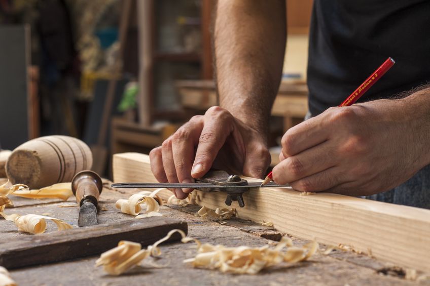 Carpenter measuring a piece of wood