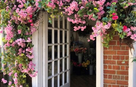 Florist doorway surrounded with pink flowers
