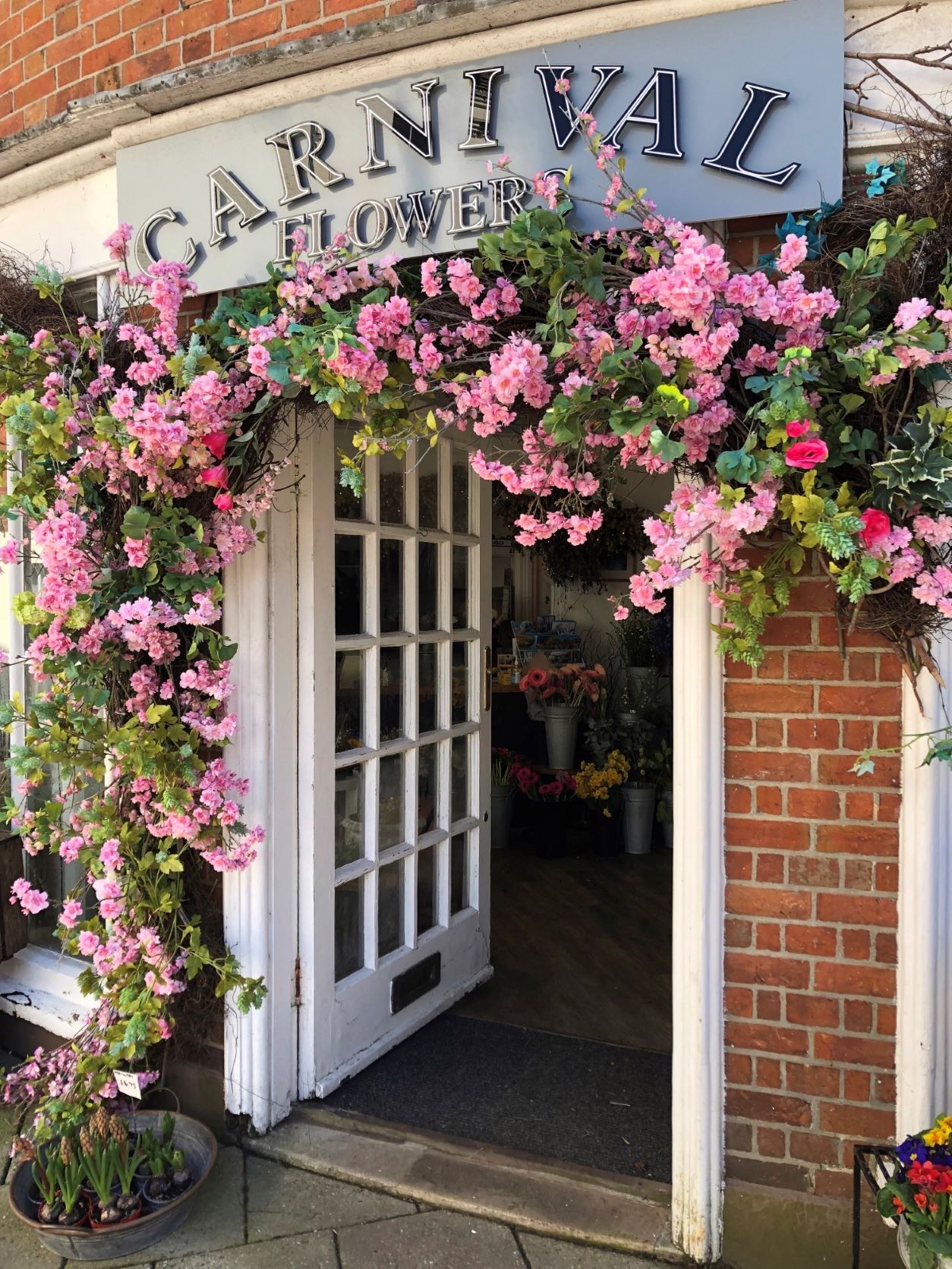 Florist doorway surrounded with pink flowers