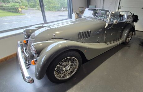 Grey Morgan sports car in showroom