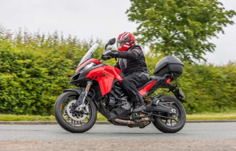 In-motion motorcyclist on red bike