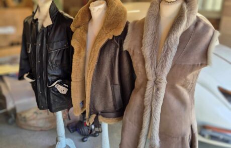 3 leather jackets on display racks